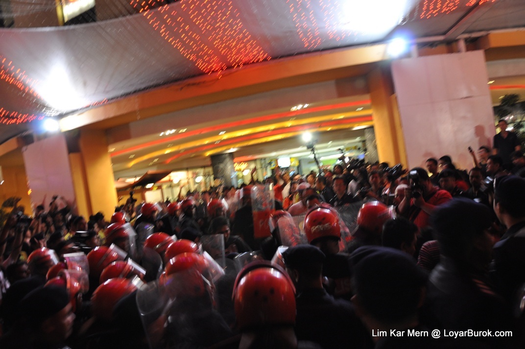 FRU charging into the gathering and forcing them inside the mall.