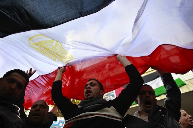 Jordanians and Egyptians living in Jordan hold up an Egyptian flag as they celebrate the resignation of Egypt's president Hosni Mubarak, in Amman, on February 12, 2011 | Credit: AFP PHOTO/STR/AFP/Getty Images