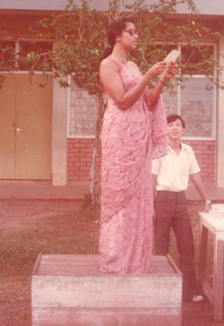 Teacher Rose Anne Easaw addressing the school assembly of Sekolah Menegah Inggeris/Kebangsaan, Yong Peng in 1977. Standing behind her is the writer.